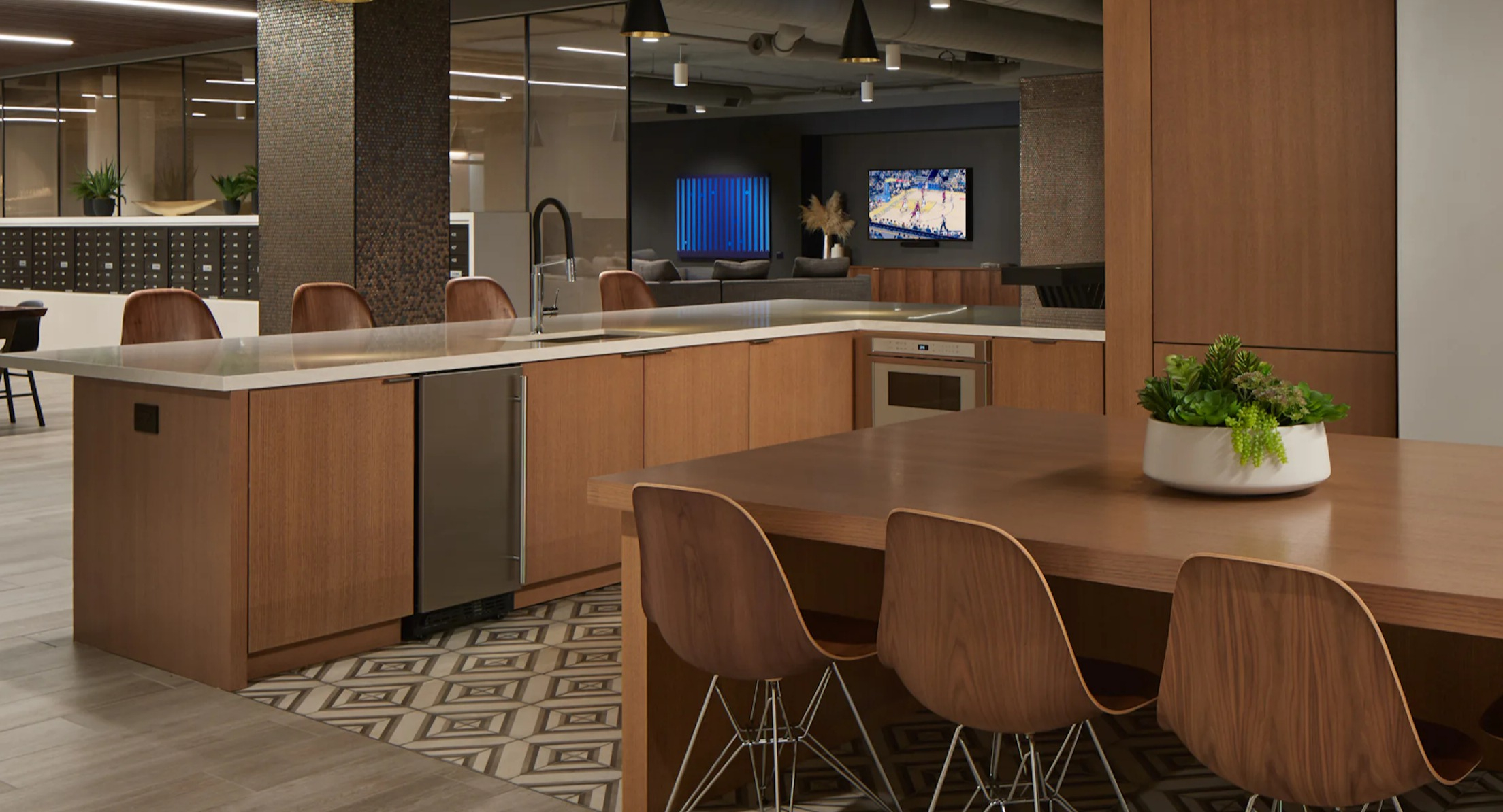 Modern resident lounge and shared kitchen area, perfect for entertaining and gatherings at Cascade Lakeshore East in Chicago