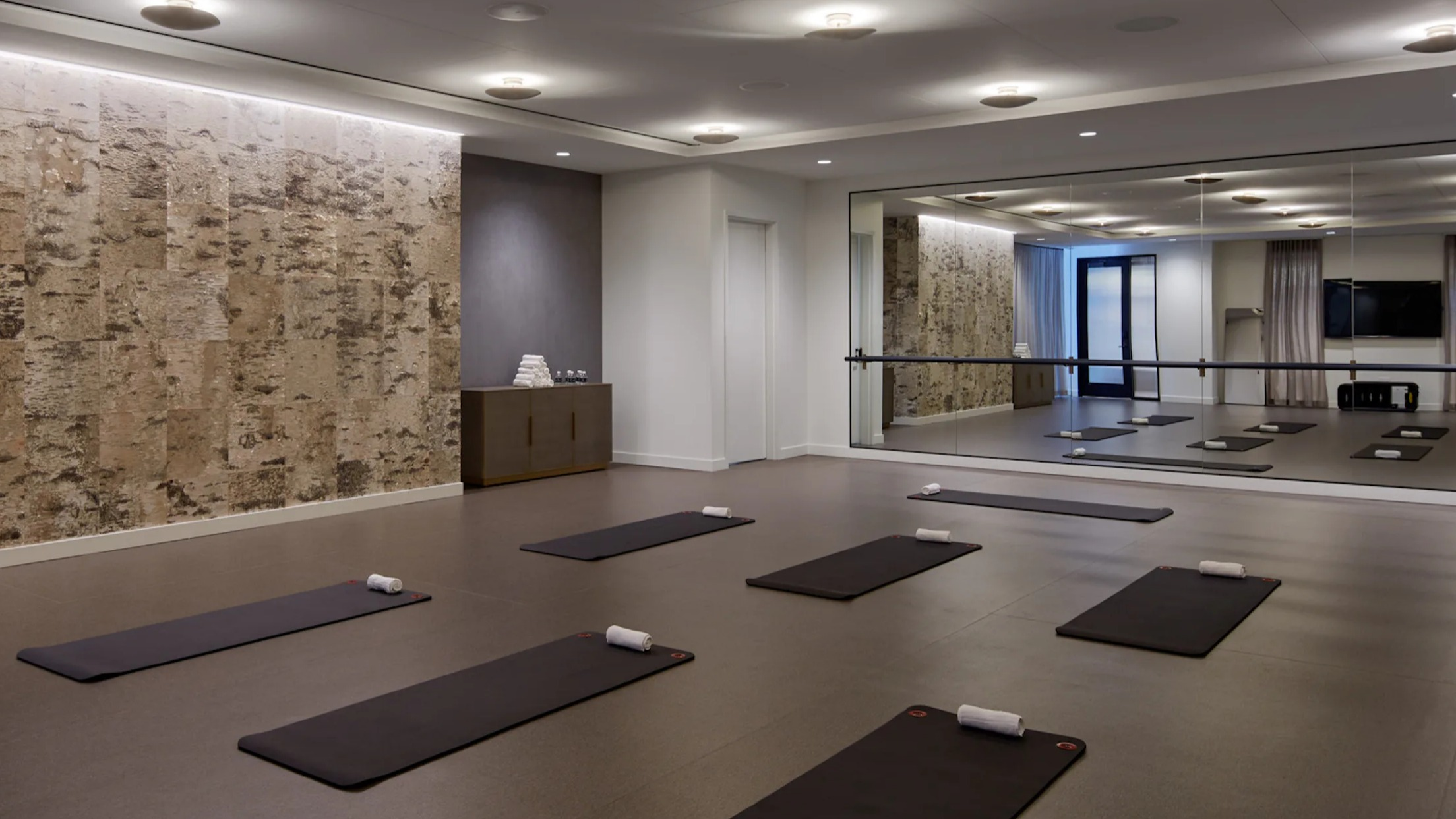Spacious yoga and meditation studio with exercise mats and a ballet barre at Cascade Lakeshore East in Chicago