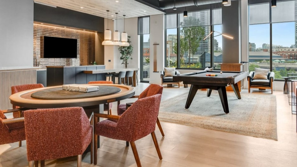 Vibrant apartment game room with a billiards table, comfortable seating, and a poker table, perfect for entertainment at Cassidy on Canal in Chicago