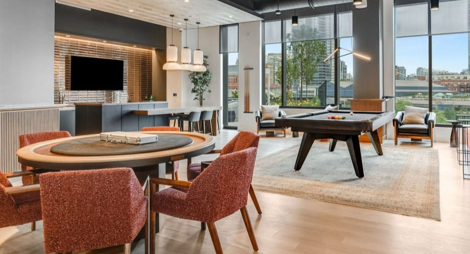 Vibrant apartment game room with a billiards table, comfortable seating, and a poker table, perfect for entertainment at Cassidy on Canal in Chicago