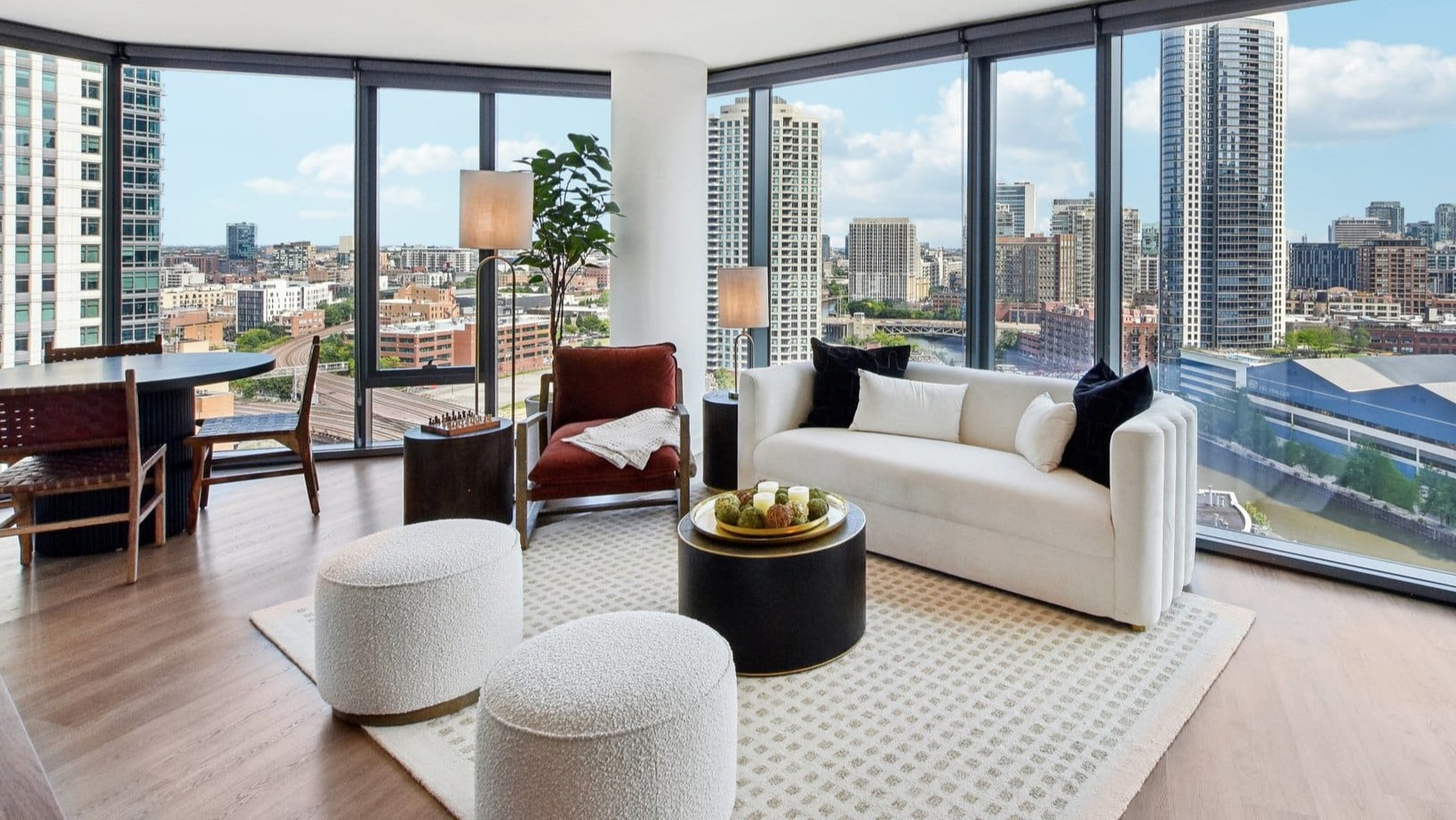 Luxurious open-concept living and dining area with panoramic city views, modern furniture, and a spacious layout at Cassidy on Canal in Chicago
