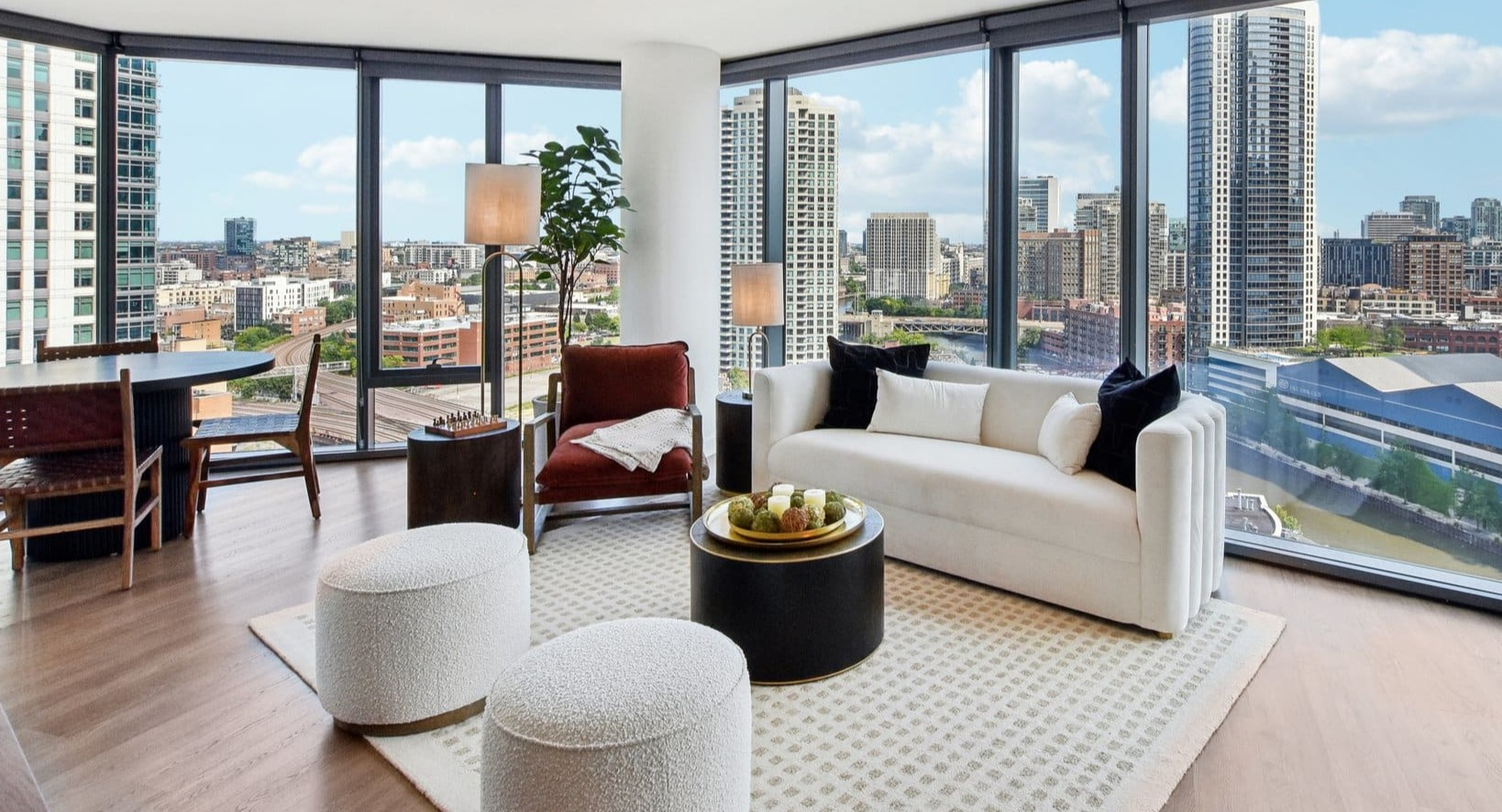 Luxurious open-concept living and dining area with panoramic city views, modern furniture, and a spacious layout at Cassidy on Canal in Chicago