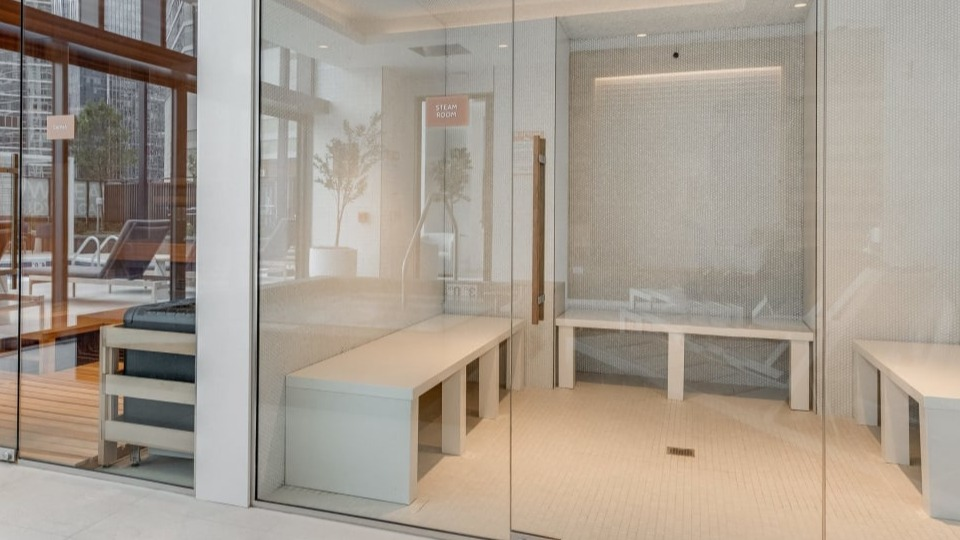 Modern sauna and steam room facilities with clear glass doors, designed for ultimate relaxation at Cassidy on Canal apartments in Chicago