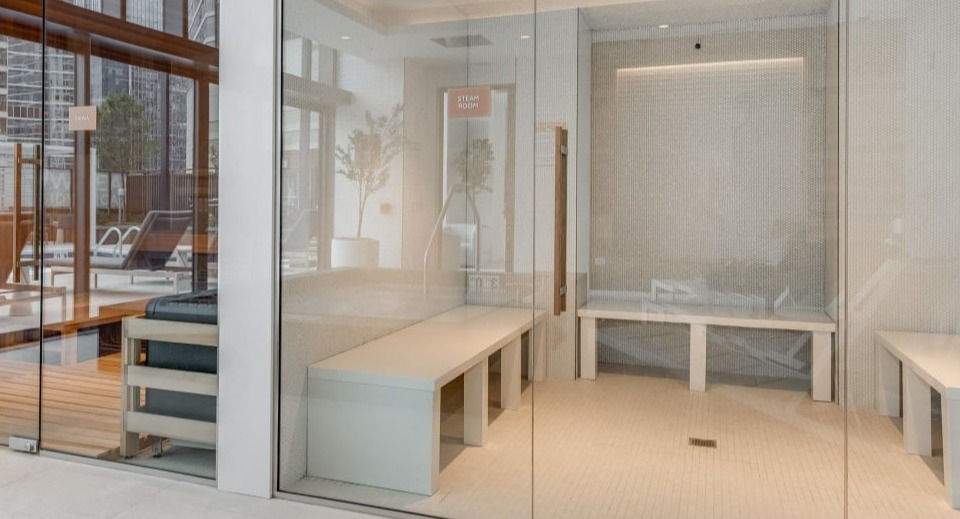 Modern sauna and steam room facilities with clear glass doors, designed for ultimate relaxation at Cassidy on Canal apartments in Chicago