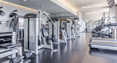 Expansive fitness center at Catalyst apartments in Chicago, featuring a range of cardio machines and free weights
