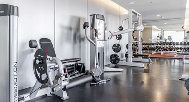 Well-equipped fitness center at Catalyst apartments in Chicago with various weight machines for strength training