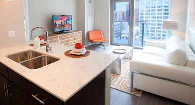 Compact and modern kitchen and living area at Catalyst apartments in Chicago, designed for efficiency and style