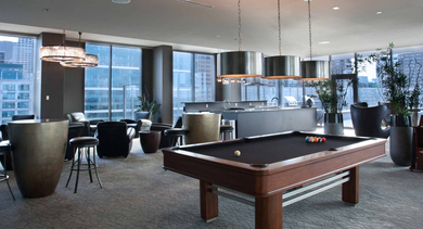 Inviting resident lounge at Catalyst apartments in Chicago, featuring a billiards table and comfortable seating areas