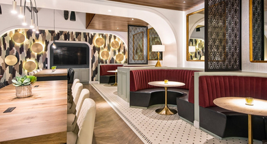 Chic dining and lounge area with velvet booth seating and modern lighting, perfect for socializing at Century Tower Apartments Chicago