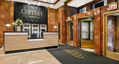 Elegant lobby and entrance with a concierge desk, marble finishes, and art deco styling at Century Tower Apartments Chicago