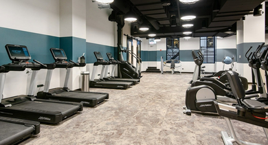 Modern fitness center with a variety of cardio equipment, including treadmills and ellipticals at Century Tower Apartments Chicago