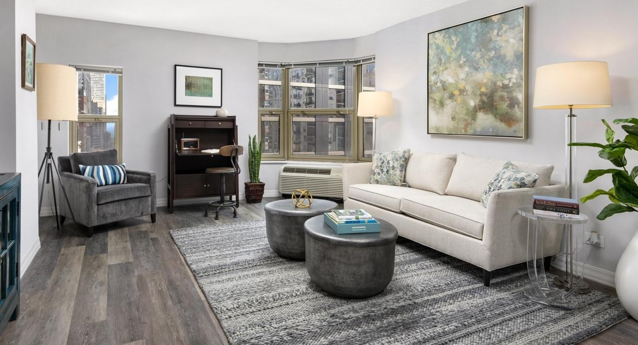 Spacious living room at Chestnut Place apartments in Chicago, featuring a designated home office nook and city views