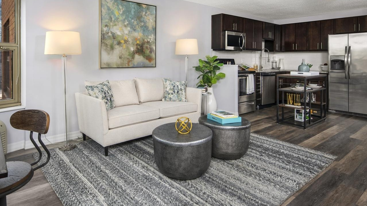 Combined living room and kitchen area at Chestnut Place apartments in Chicago, offering a spacious and functional layout