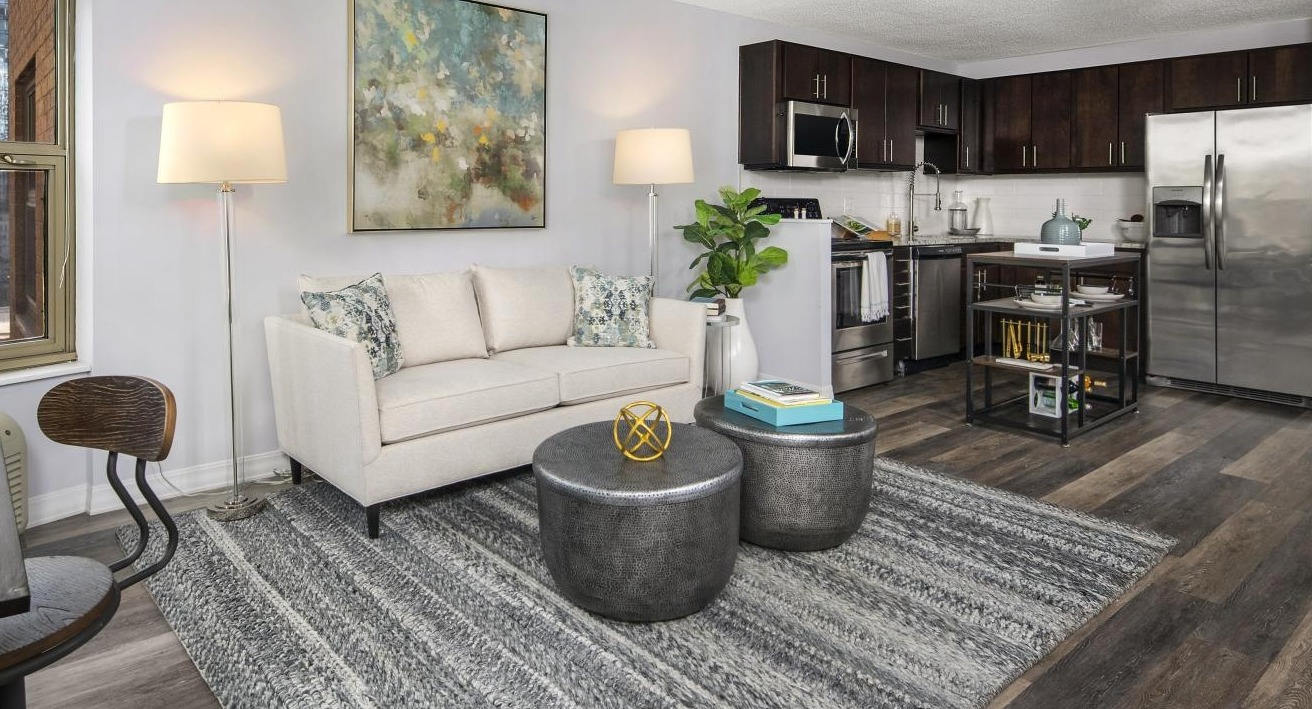 Combined living room and kitchen area at Chestnut Place apartments in Chicago, offering a spacious and functional layout