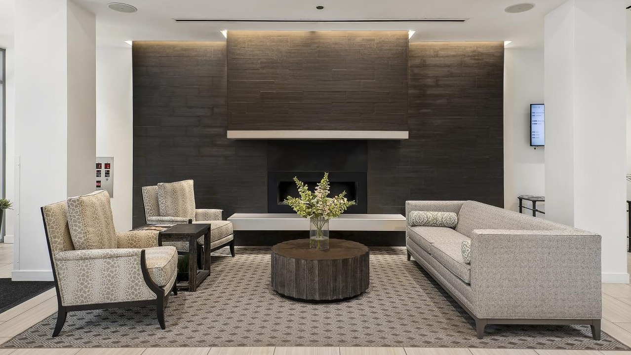Luxurious lobby lounge at Chestnut Place apartments in Chicago, featuring a modern fireplace and comfortable seating