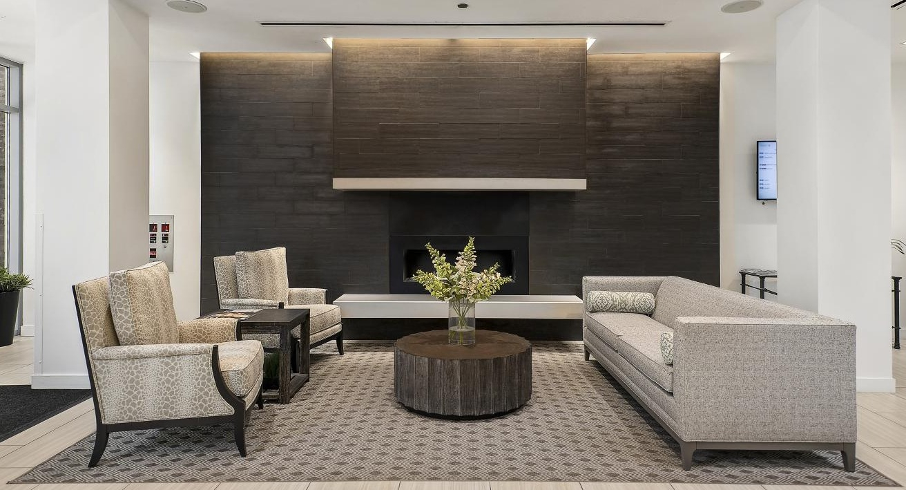 Luxurious lobby lounge at Chestnut Place apartments in Chicago, featuring a modern fireplace and comfortable seating