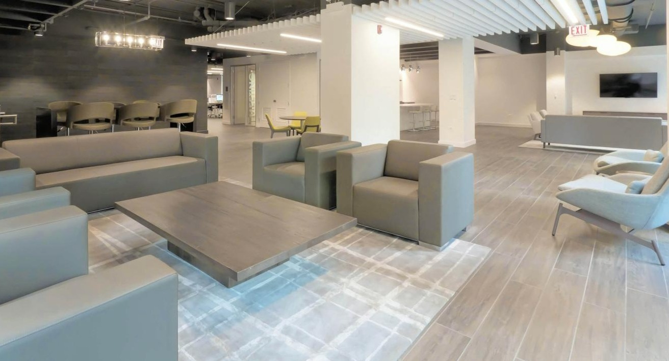 Inviting resident lounge at Chestnut Place apartments in Chicago with comfortable sofas, chairs, and modern lighting