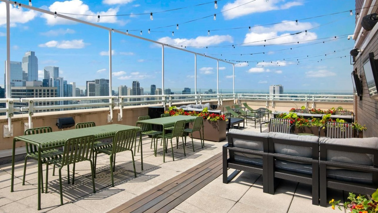 A spacious rooftop deck at Chestnut Towers, equipped with various seating areas, perfect for relaxing with city views