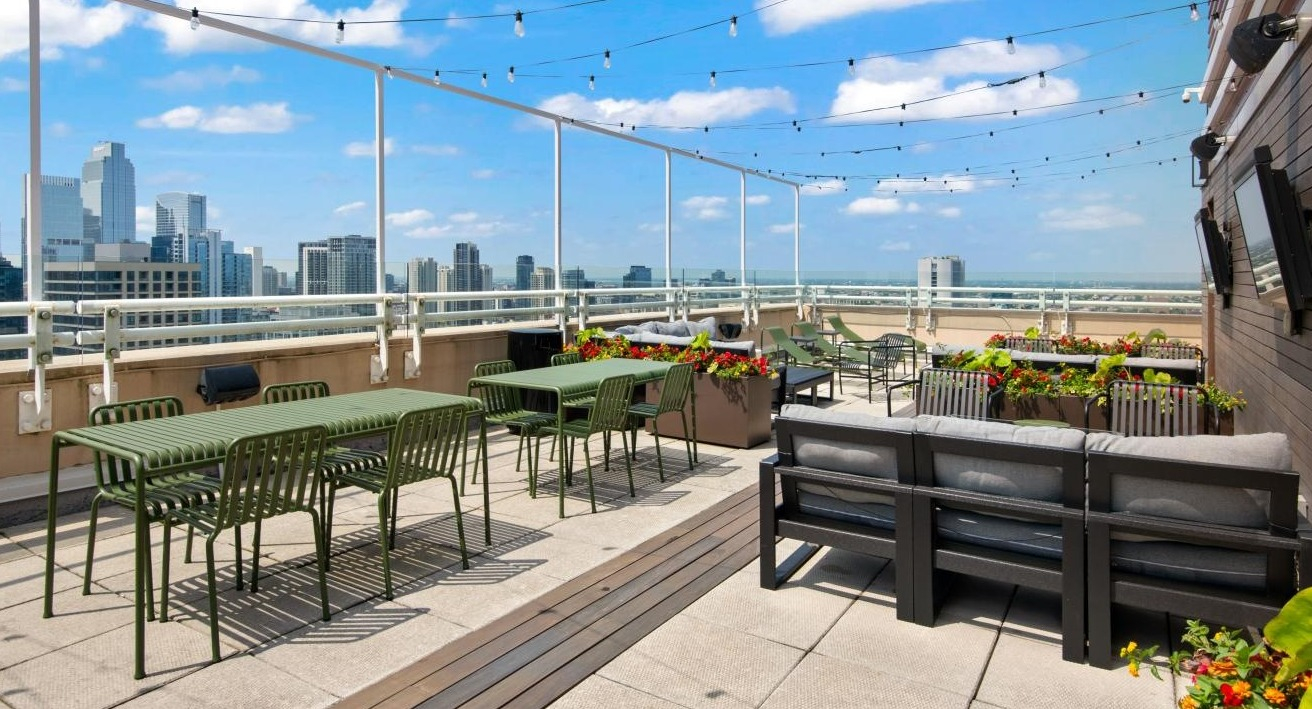 A spacious rooftop deck at Chestnut Towers, equipped with various seating areas, perfect for relaxing with city views