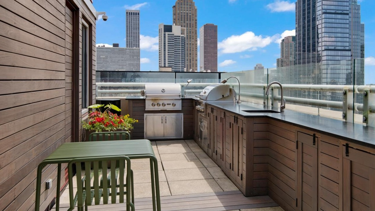 A fantastic rooftop grilling deck at Chestnut Towers, complete with a BBQ station and outdoor dining furniture