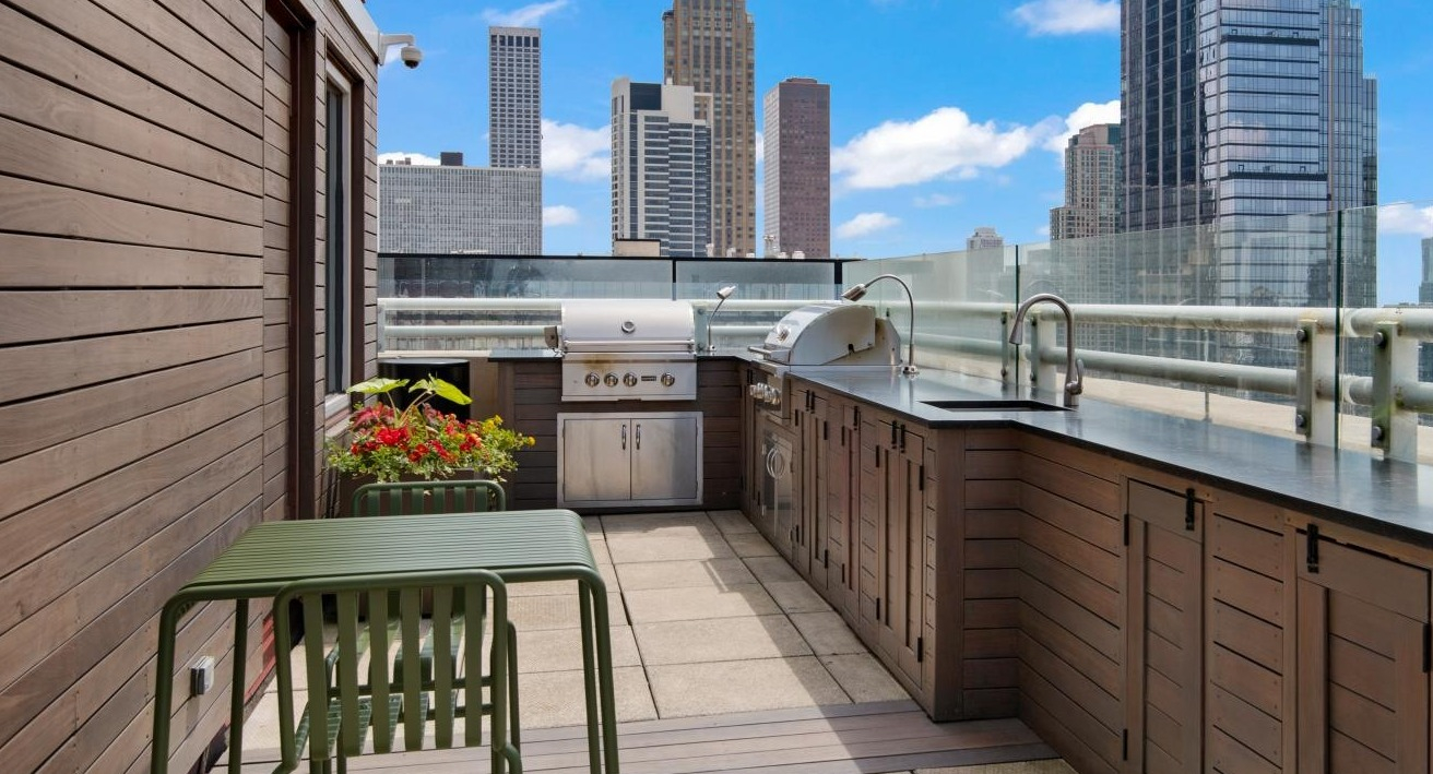 A fantastic rooftop grilling deck at Chestnut Towers, complete with a BBQ station and outdoor dining furniture