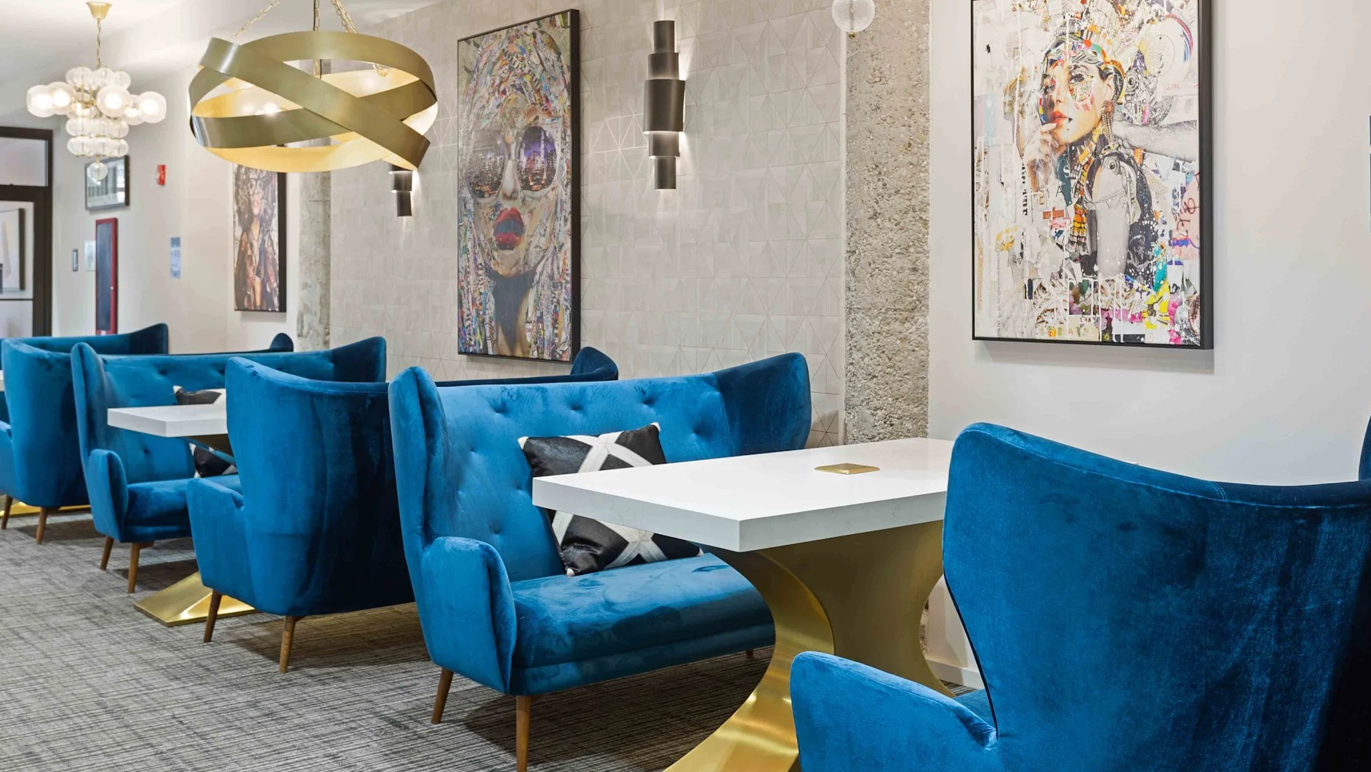 Modern coworking lounge with plush blue seating and individual tables, perfect for productivity at Circa 922 apartments in Chicago