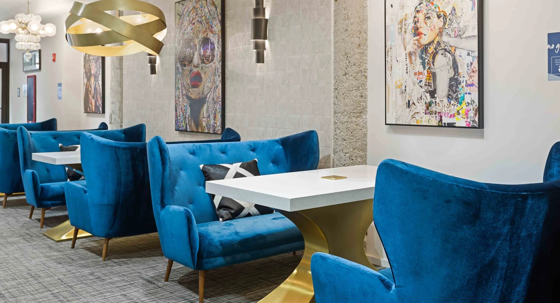 Modern coworking lounge with plush blue seating and individual tables, perfect for productivity at Circa 922 apartments in Chicago