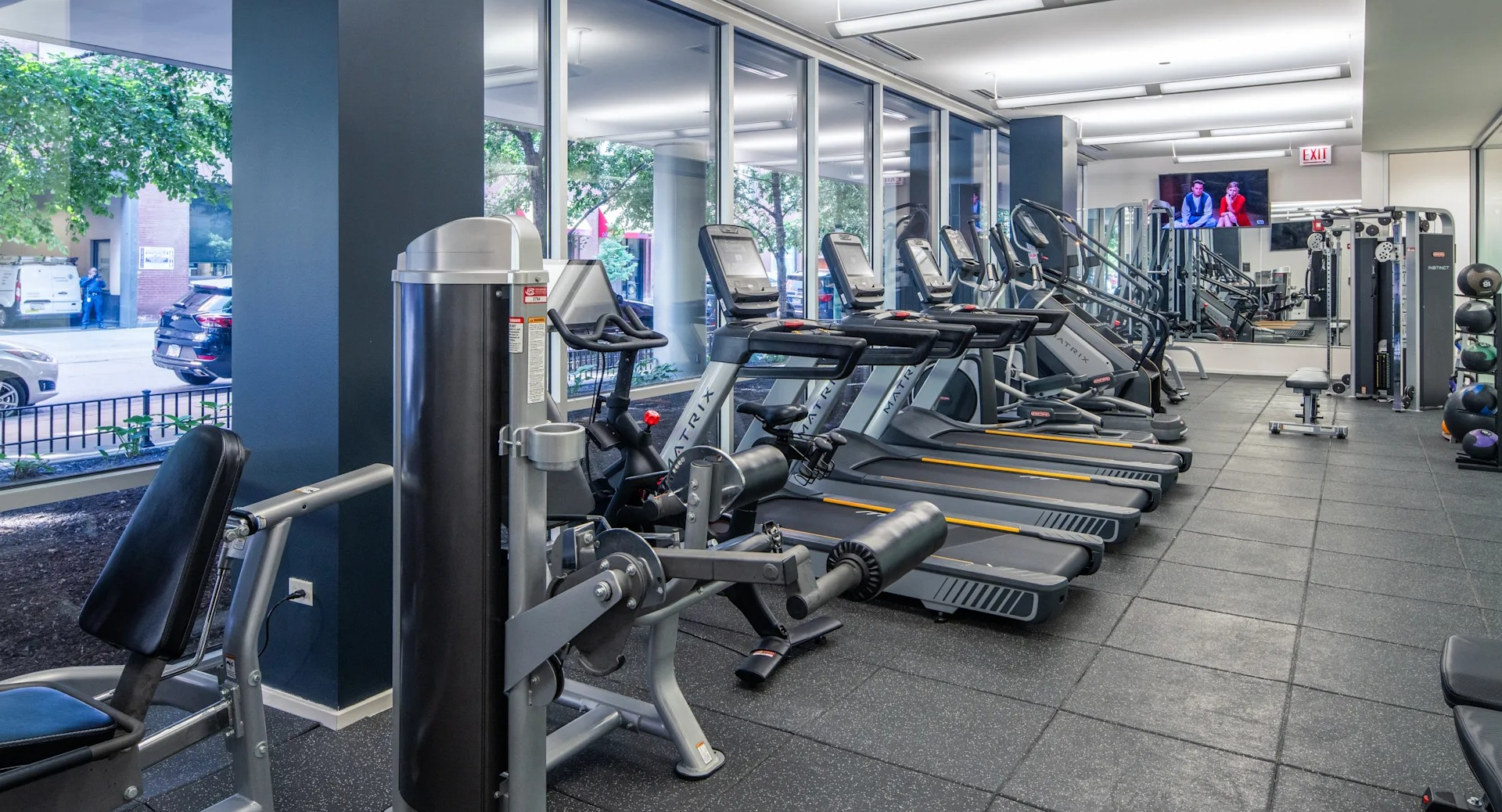 Expansive fitness center with a wide array of cardio machines, strength training equipment, and large windows at Circa 922 in Chicago