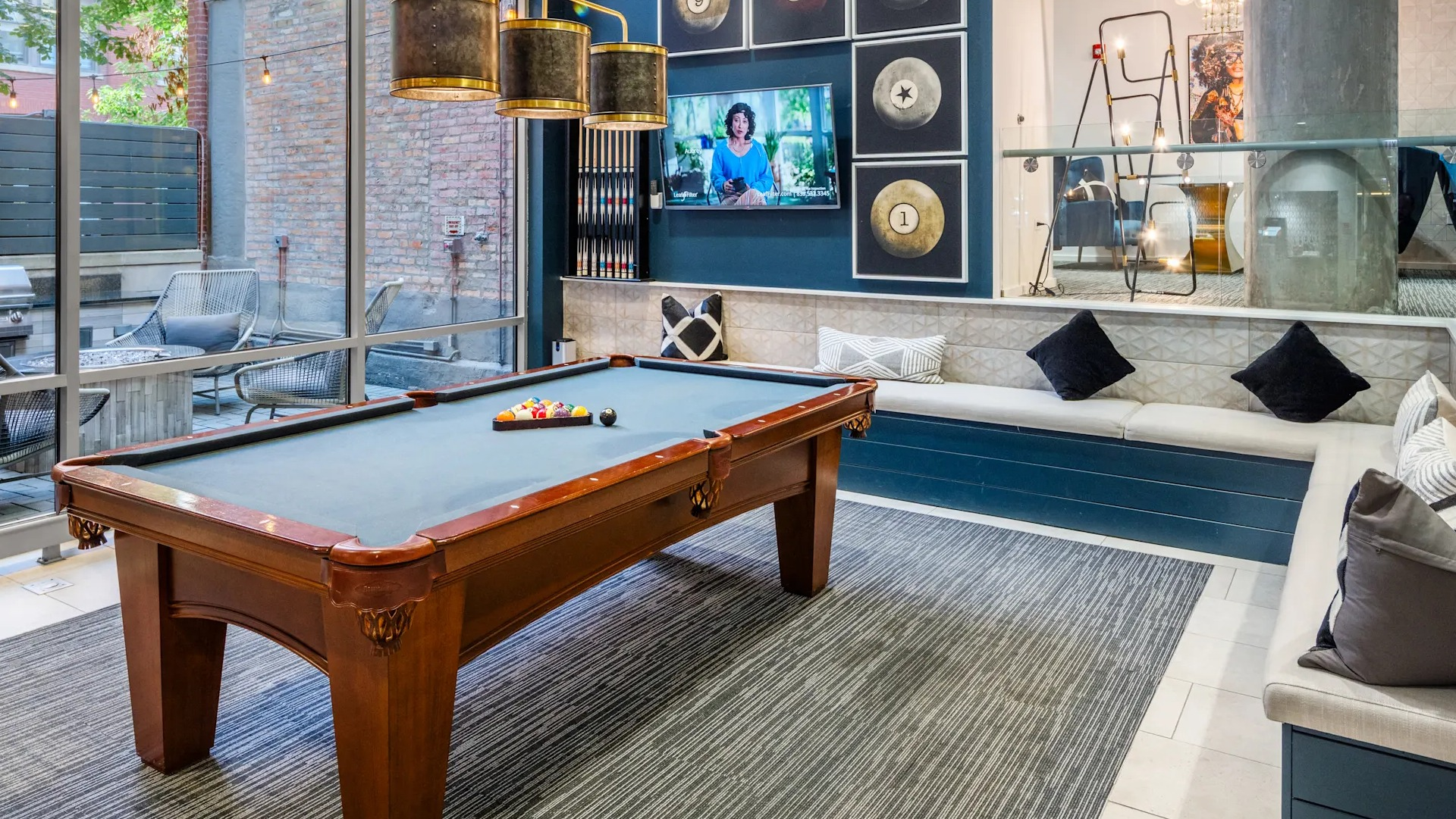 Stylish game room with a billiards table, comfortable banquette seating, and modern decor at Circa 922 apartments in Chicago