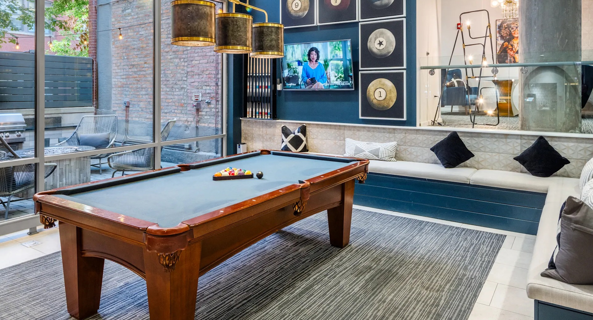 Stylish game room with a billiards table, comfortable banquette seating, and modern decor at Circa 922 apartments in Chicago