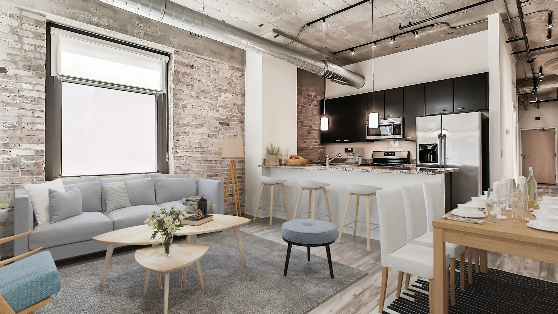 Modern loft-style apartment featuring exposed brick, high ceilings, a stylish living area, and a functional kitchen at Circa 922 in Chicago