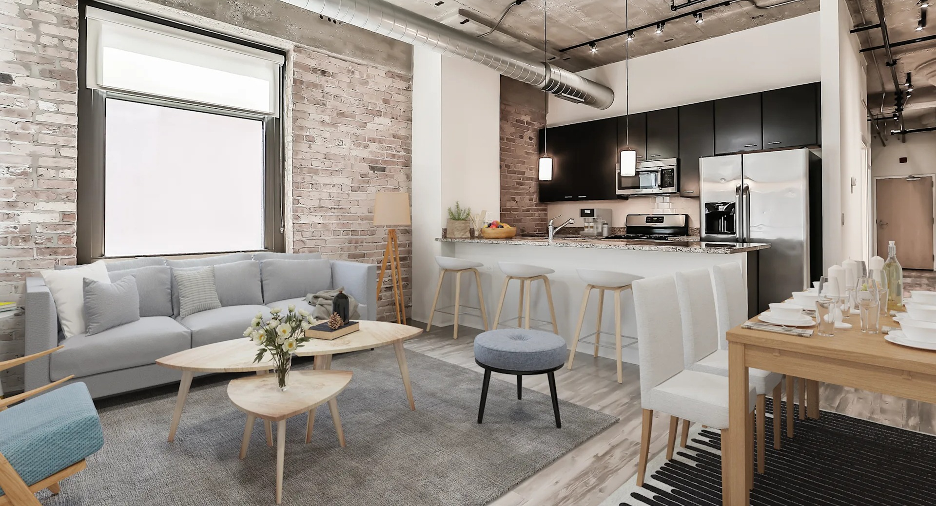 Modern loft-style apartment featuring exposed brick, high ceilings, a stylish living area, and a functional kitchen at Circa 922 in Chicago