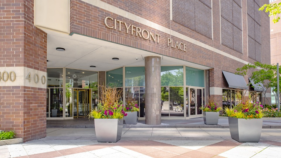 Grand exterior entrance of Cityfront Place apartments, featuring elegant planters and clear signage