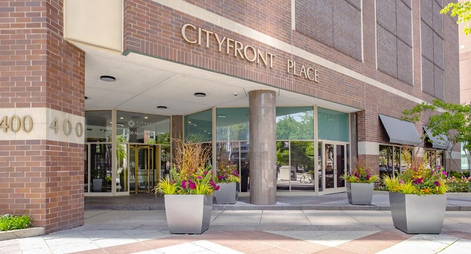 Grand exterior entrance of Cityfront Place apartments, featuring elegant planters and clear signage