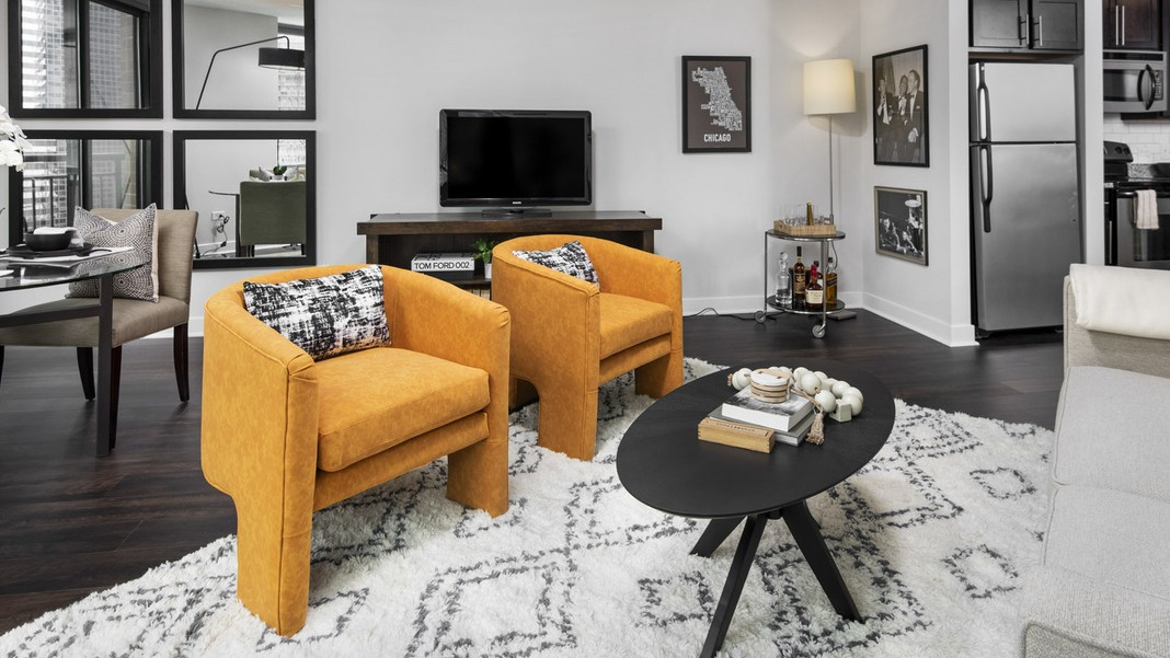 Chic living and dining space at Cityfront Place featuring elegant seating, a modern dining table, and dark flooring