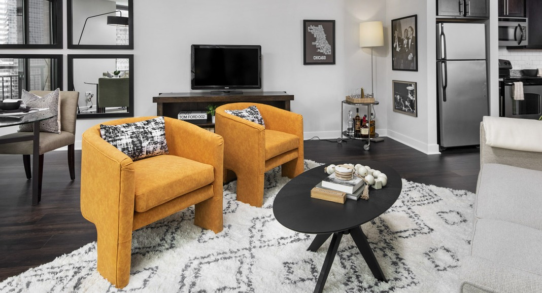 Chic living and dining space at Cityfront Place featuring elegant seating, a modern dining table, and dark flooring