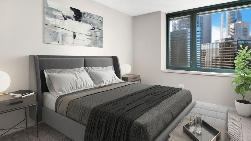 Cozy bedroom at Cityfront Place featuring a queen-sized bed, stylish nightstands, and panoramic city views