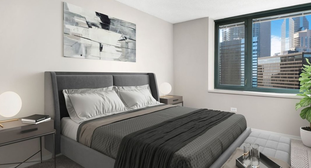 Cozy bedroom at Cityfront Place featuring a queen-sized bed, stylish nightstands, and panoramic city views