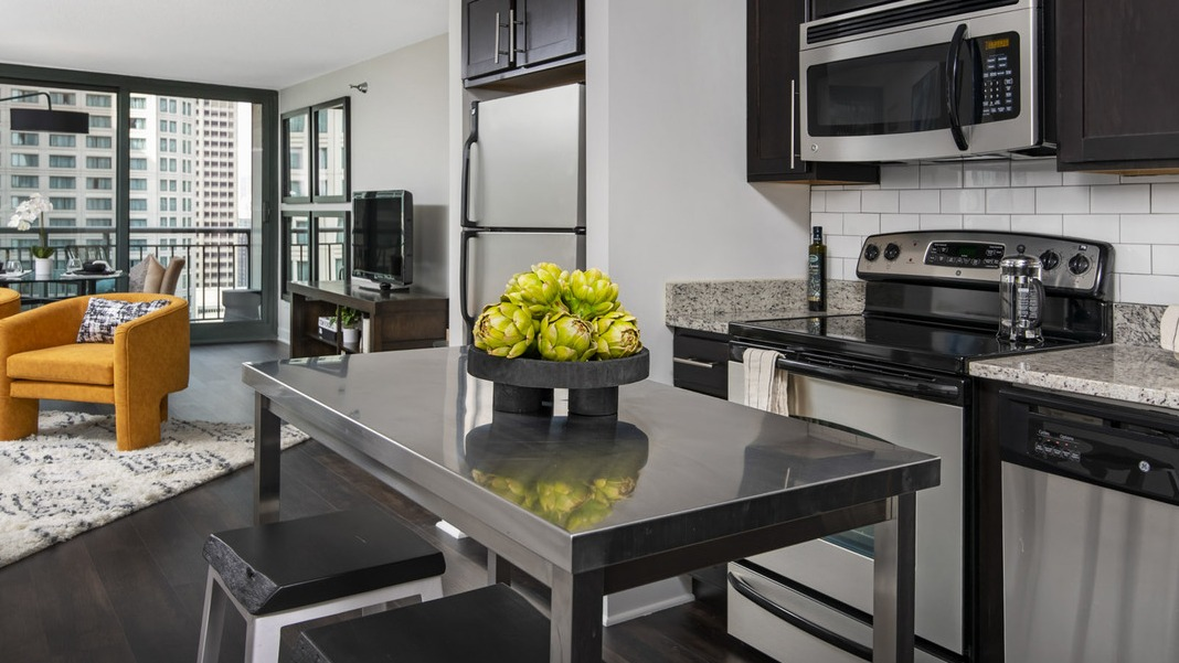 Well-appointed kitchen at Cityfront Place with a spacious island, opening directly into a bright living area