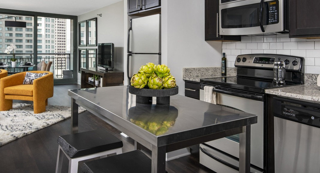 Well-appointed kitchen at Cityfront Place with a spacious island, opening directly into a bright living area