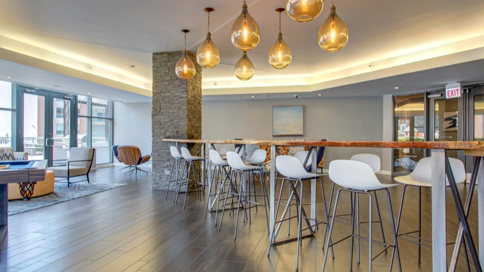 Spacious resident lounge at Cityfront Place featuring a pool table, bar seating, and stylish lighting