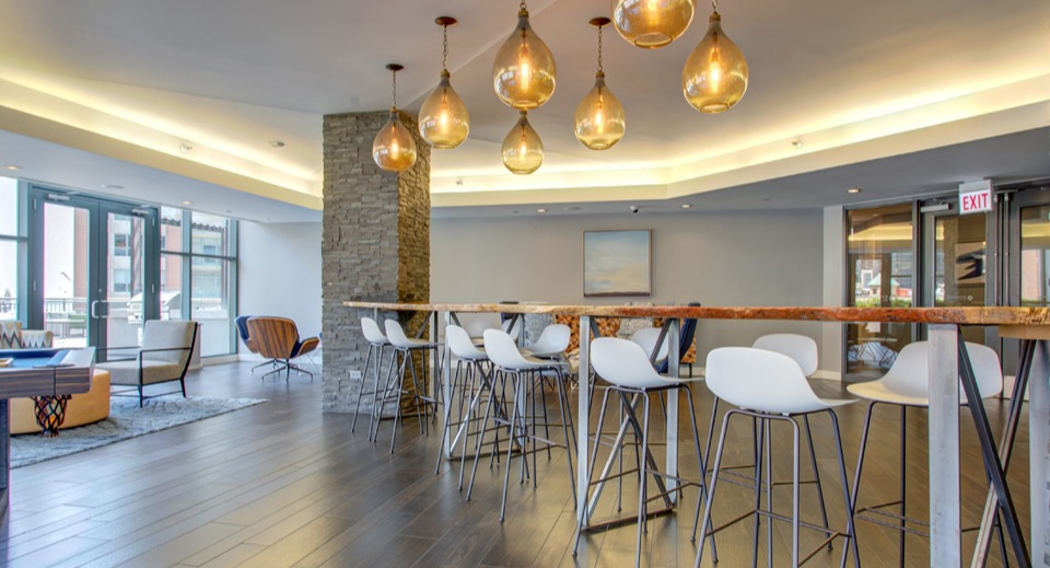 Spacious resident lounge at Cityfront Place featuring a pool table, bar seating, and stylish lighting