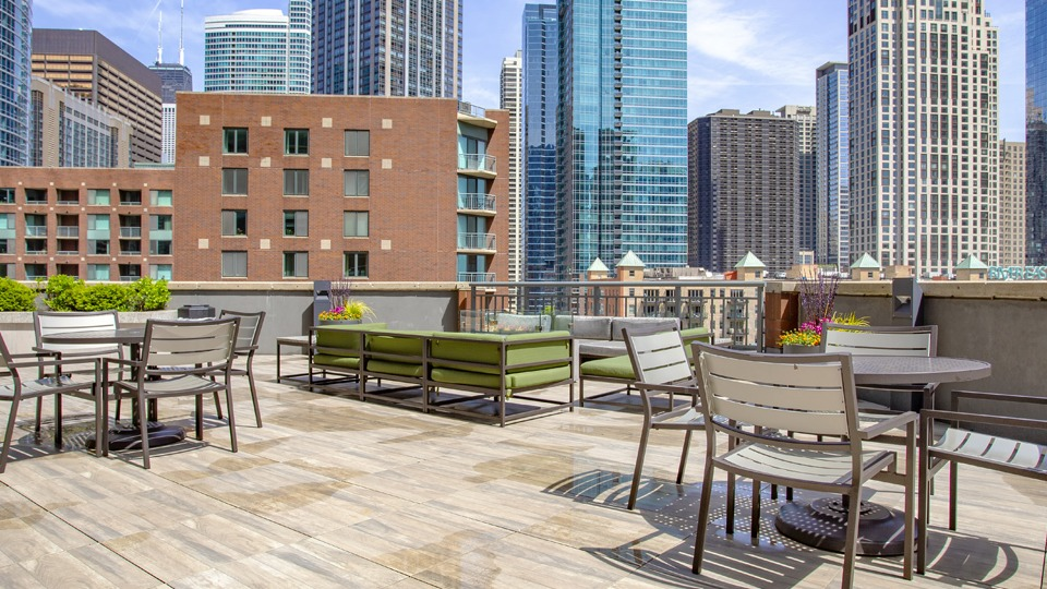 Expansive rooftop patio at Cityfront Place with dining tables, seating areas, and stunning city views