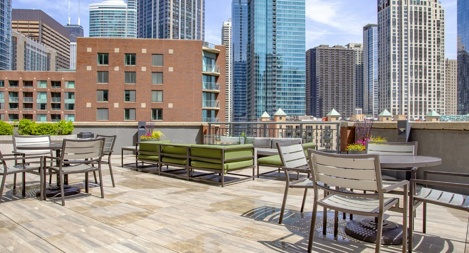Expansive rooftop patio at Cityfront Place with dining tables, seating areas, and stunning city views