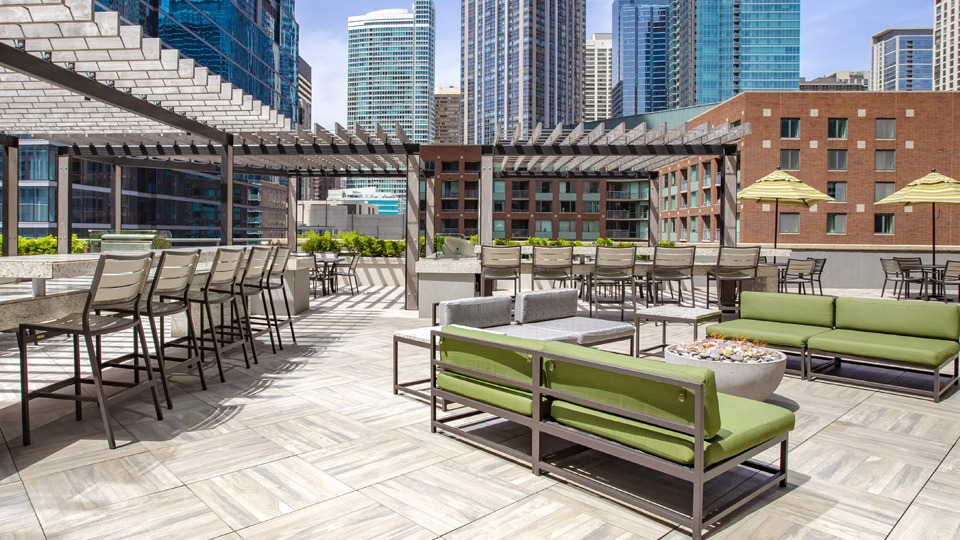 Luxurious rooftop terrace at Cityfront Place with diverse seating arrangements, pergolas, and cityscapes