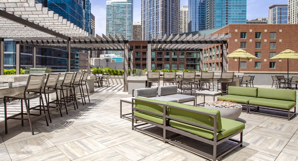 Luxurious rooftop terrace at Cityfront Place with diverse seating arrangements, pergolas, and cityscapes