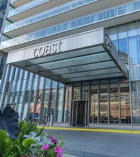Modern building entrance of Coast at Lakeshore East apartments in Chicago. Features a sleek design and welcoming entryway