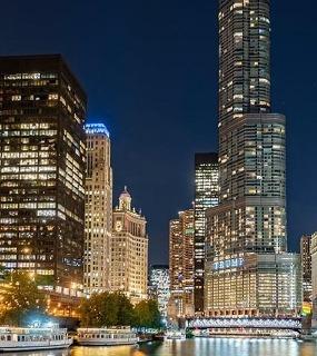 Chicago River at night with illuminated buildings, viewed from Coast at Lakeshore East apartments. 