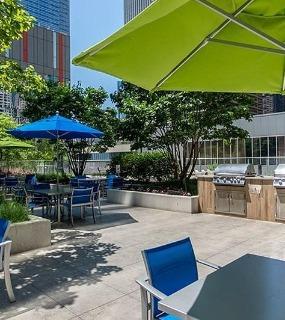 Outdoor grilling patio with seating at Coast at Lakeshore East apartments in Chicago