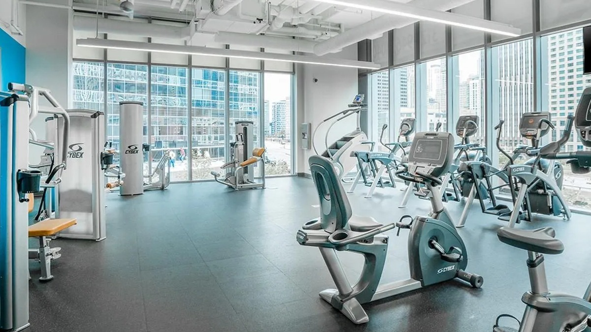 A modern gym at Coast at Lakeshore East, offering a wide array of fitness equipment and abundant natural light